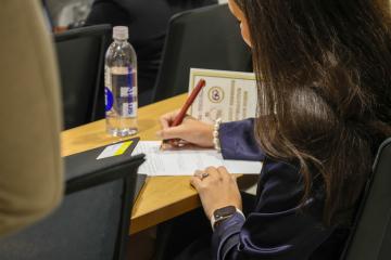 Participants Taking Notes During Morning Keynote AI Day in the Capital Event