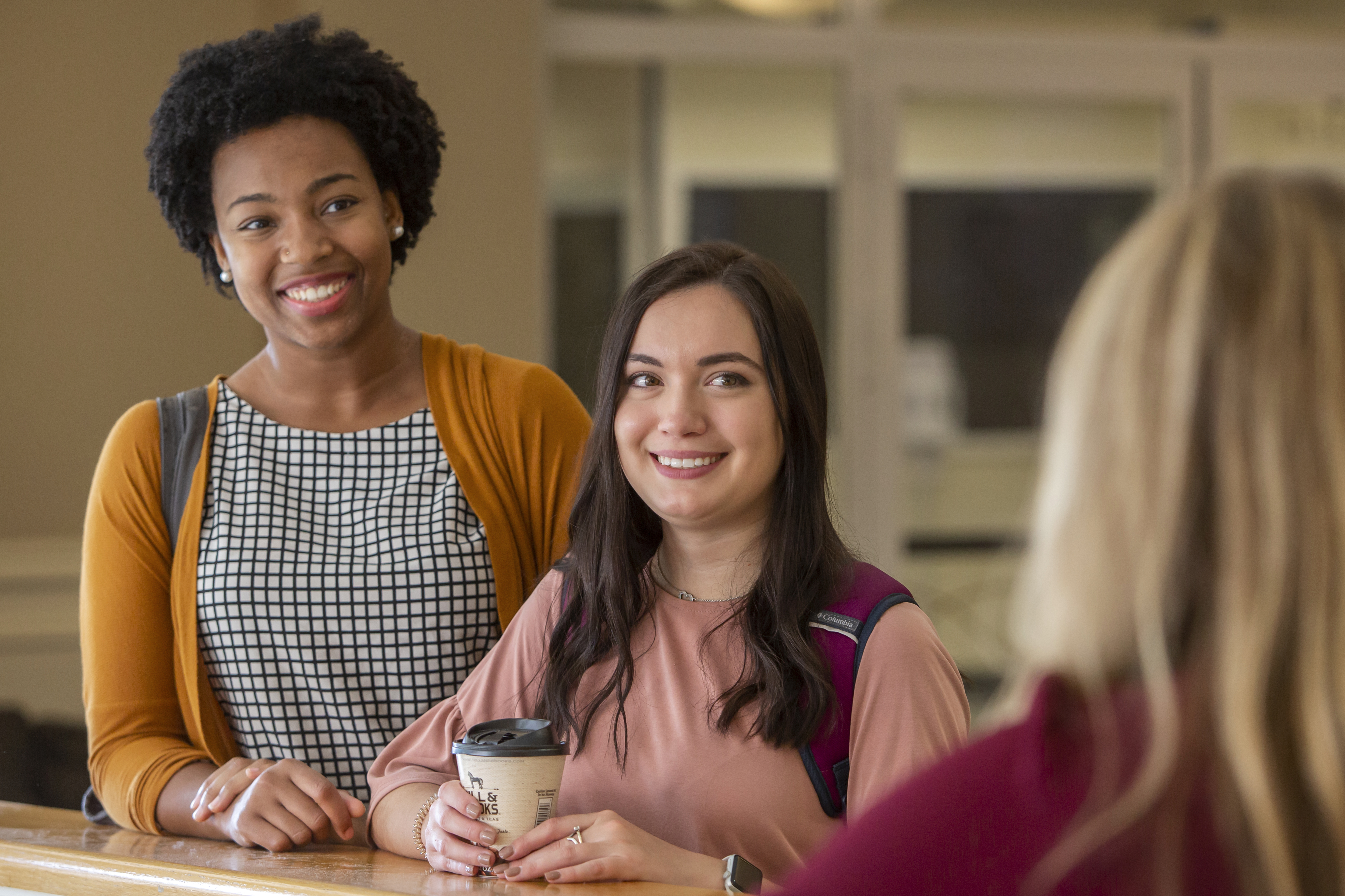 Two students chatting in campus common area