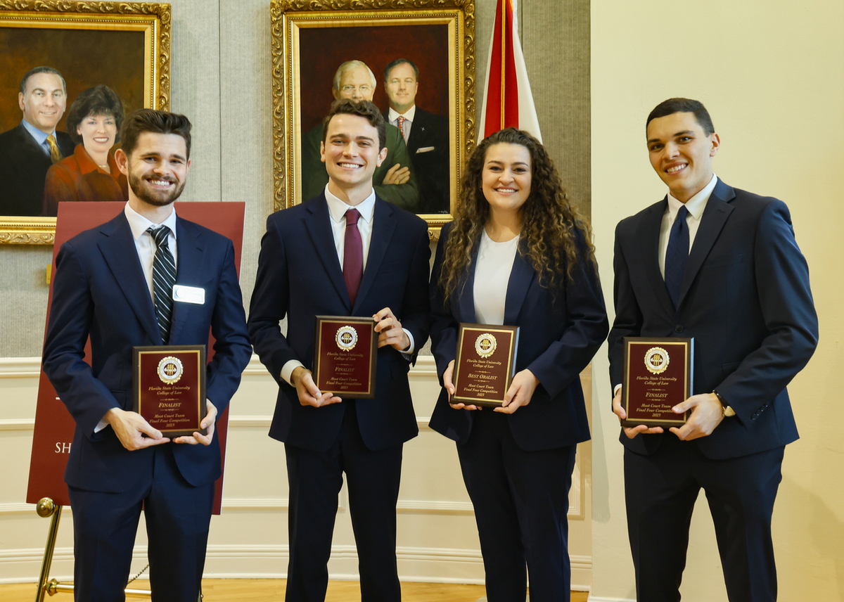 Moot Court Final Four competition winners presenting awards
